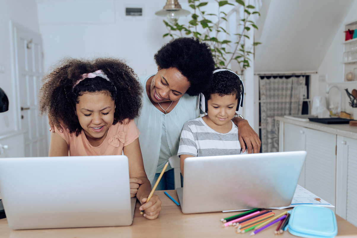 Mother supporting her children while homeschooling